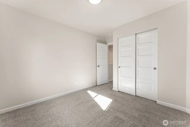 an empty room with closet area
