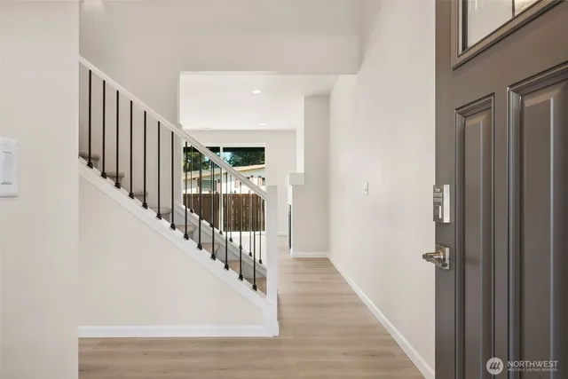 a view of a hallway with the wooden floor and entryway
