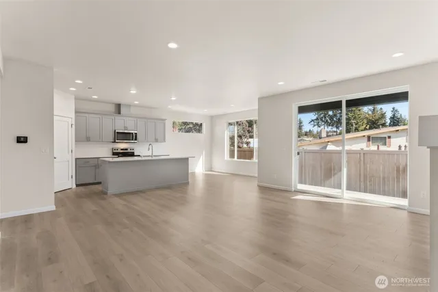 a view of kitchen with wooden floor and a window