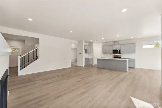 a view of kitchen with kitchen island and stainless steel appliances
