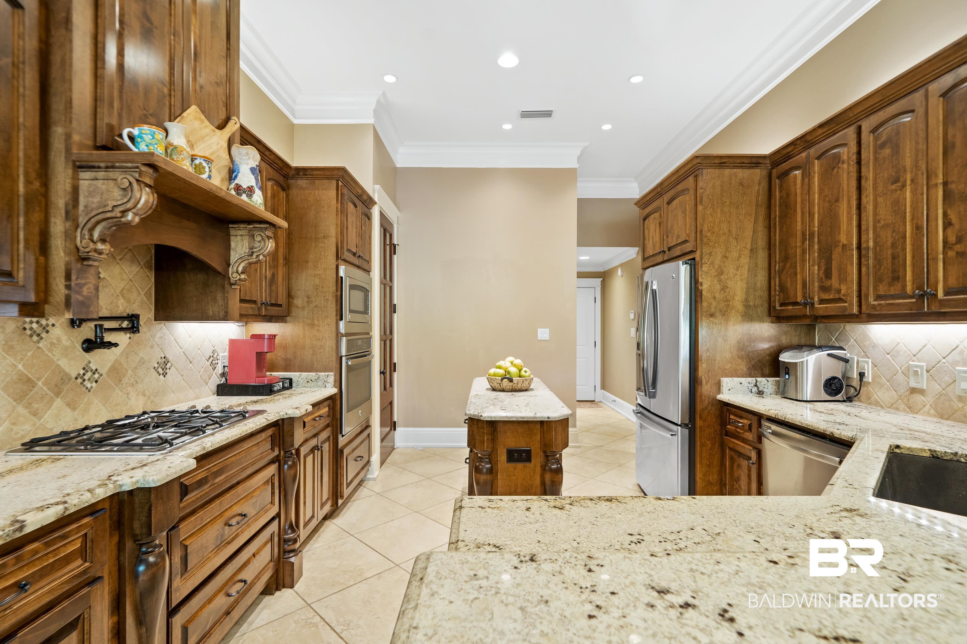 31829 Butler Drive Daphne, AL 36527 - Photo 16 of 48 Kitchen featuring ornamental molding, stainless steel appliances, light stone counters, and tasteful backsplash