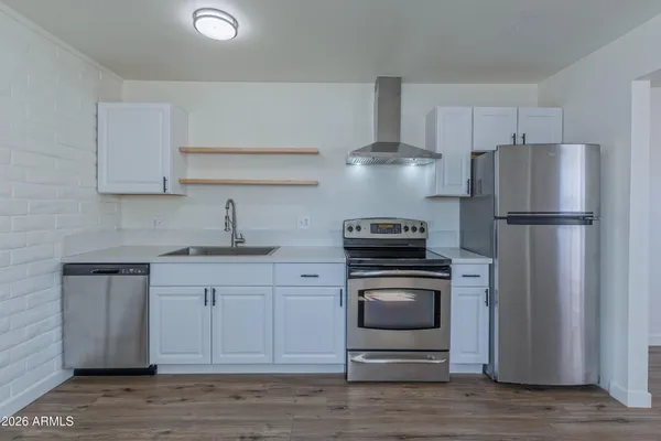a kitchen with a sink stainless steel appliances and cabinets