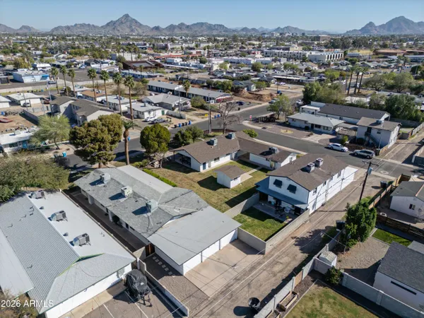 an aerial view of a residential houses with city view