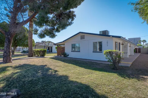 a view of a house with backyard and a tree