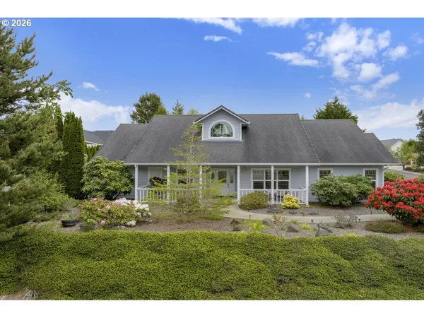 a front view of a house with a garden