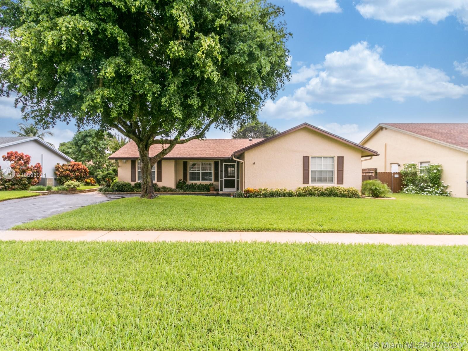 9518 Burlington Place Boca Raton, FL 33434 - Photo 1 of 35 a front view of a house with a yard