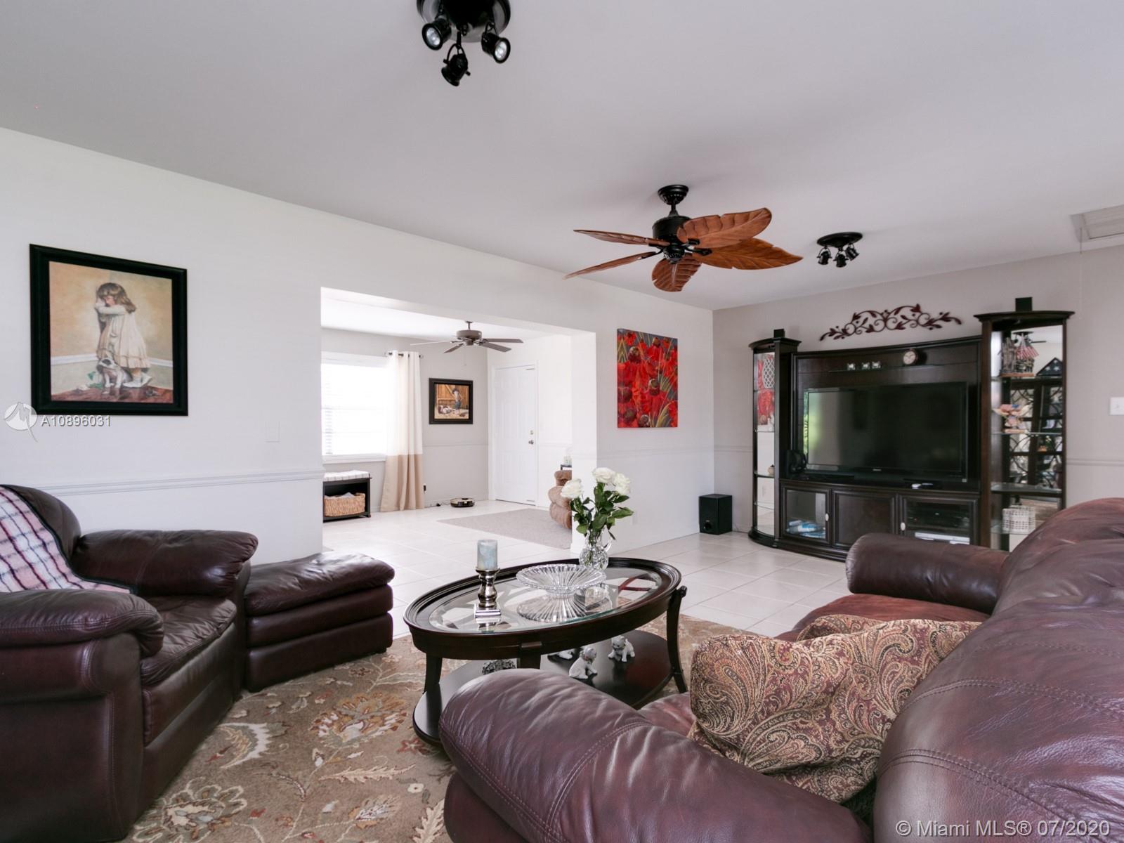9518 Burlington Place Boca Raton, FL 33434 - Photo 13 of 35 a living room with furniture and a flat screen tv