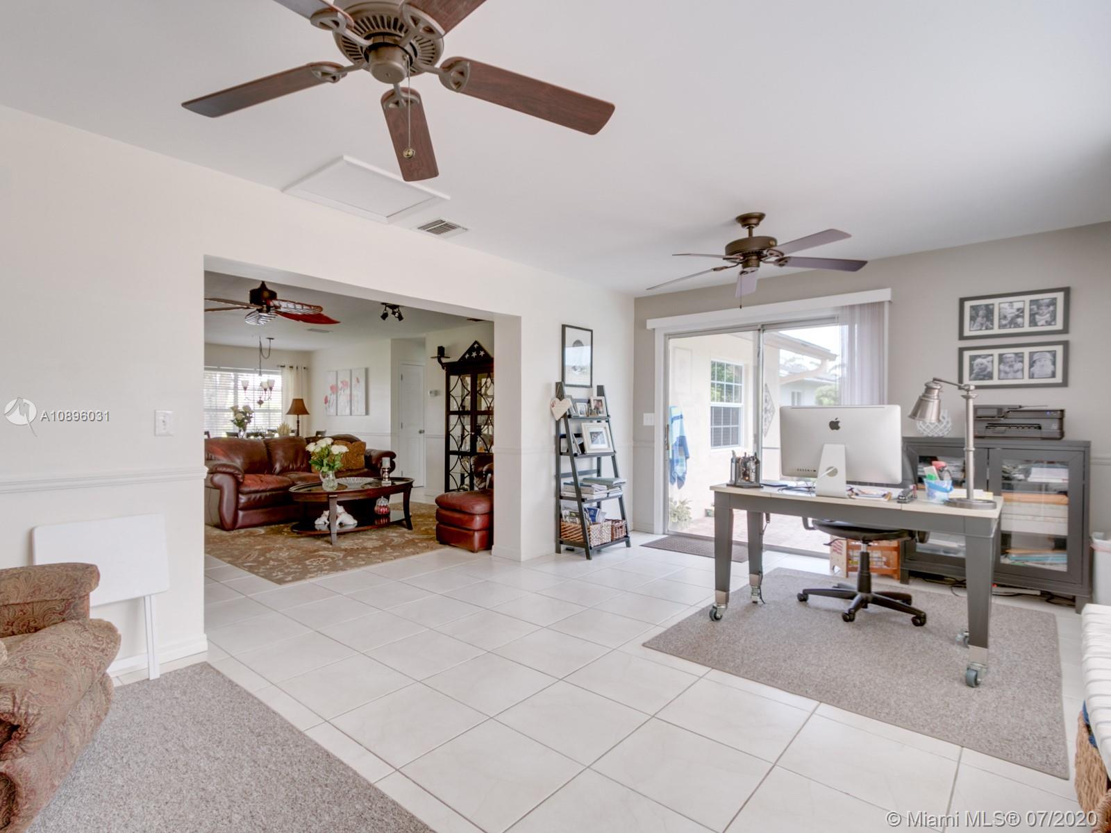 9518 Burlington Place Boca Raton, FL 33434 - Photo 19 of 35 a view of a livingroom with furniture and a ceiling fan