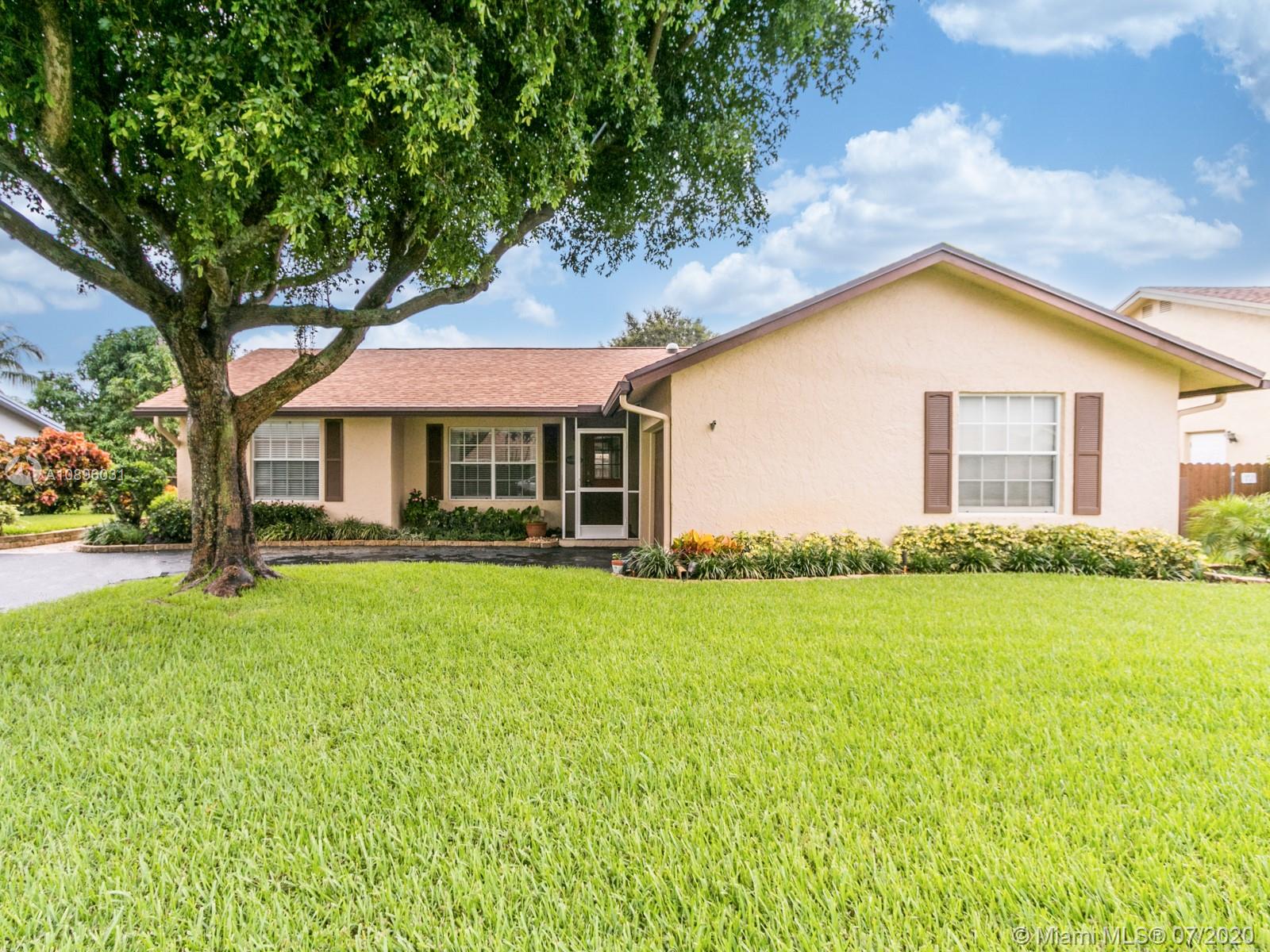 9518 Burlington Place Boca Raton, FL 33434 - Photo 2 of 35 front view of a house with a yard