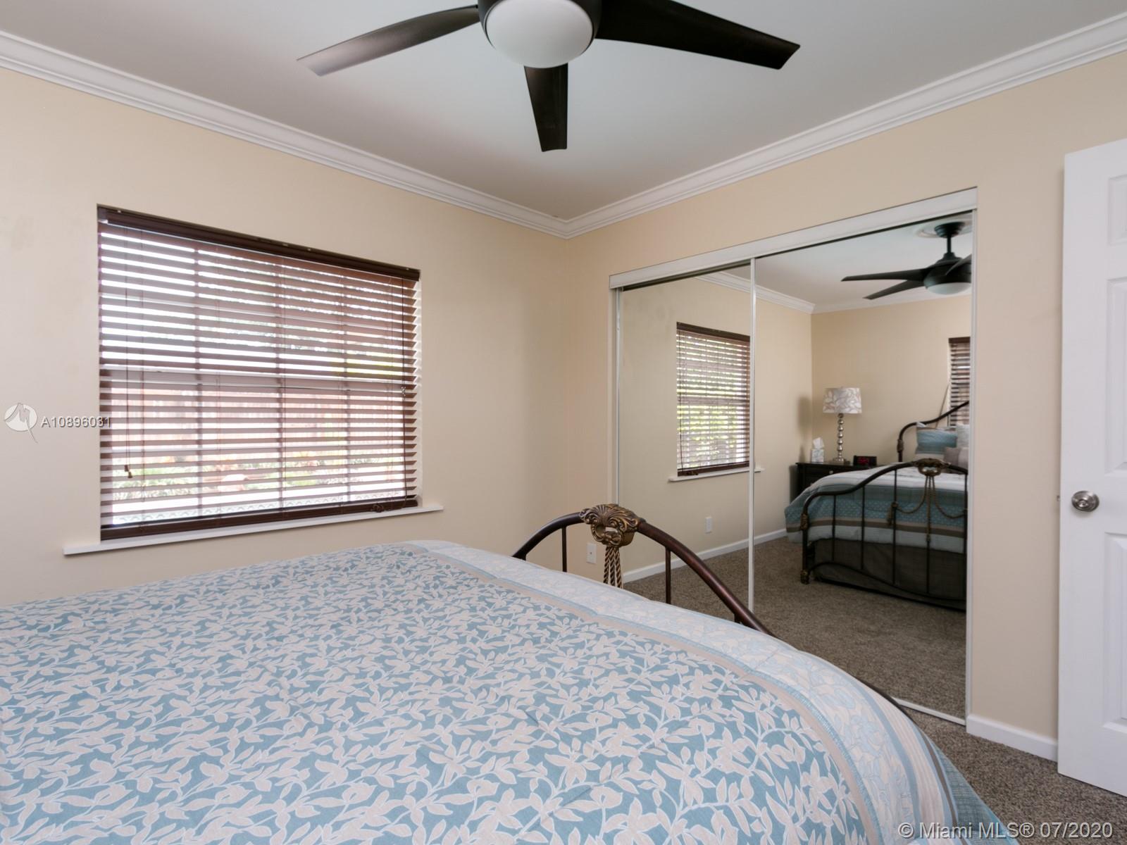 9518 Burlington Place Boca Raton, FL 33434 - Photo 25 of 35 a bedroom with a bed next to a window