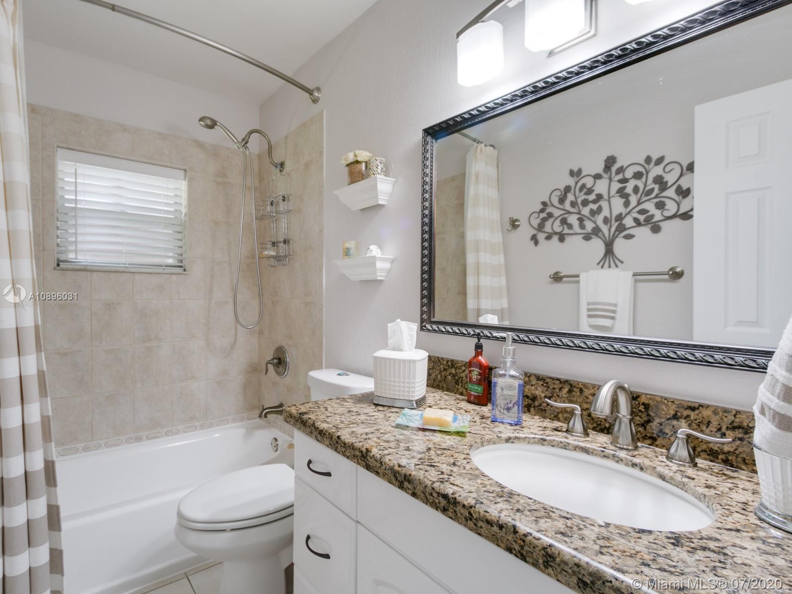 9518 Burlington Place Boca Raton, FL 33434 - Photo 26 of 35 a bathroom with a granite countertop sink toilet tub and shower