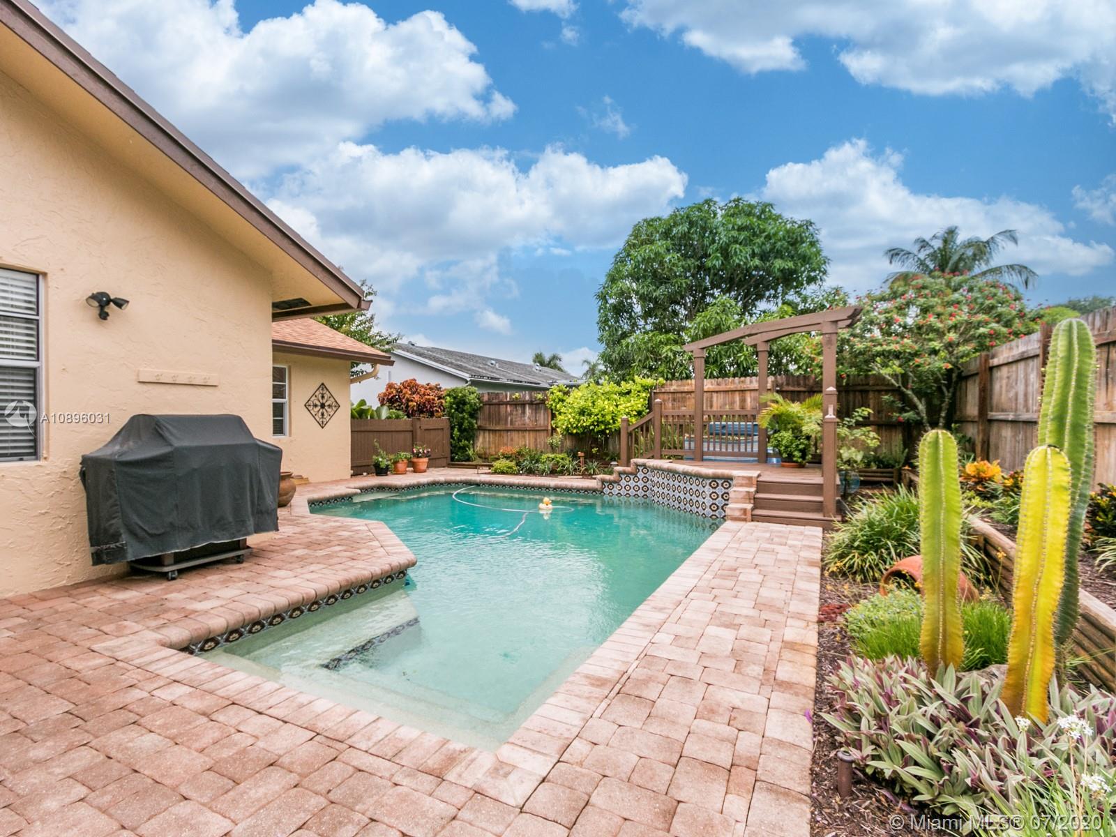 9518 Burlington Place Boca Raton, FL 33434 - Photo 31 of 35 a front view of a house with garden
