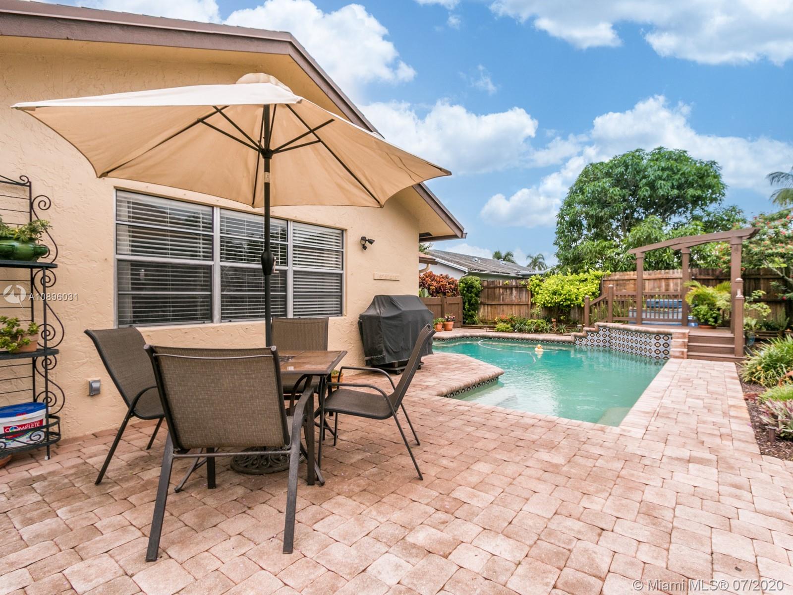 9518 Burlington Place Boca Raton, FL 33434 - Photo 32 of 35 a view of a swimming pool with lounge chair