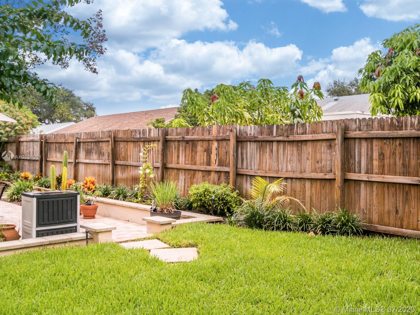 9518 Burlington Place Boca Raton, FL 33434 - Photo 34 of 35 a view of a garden with a bench in the background