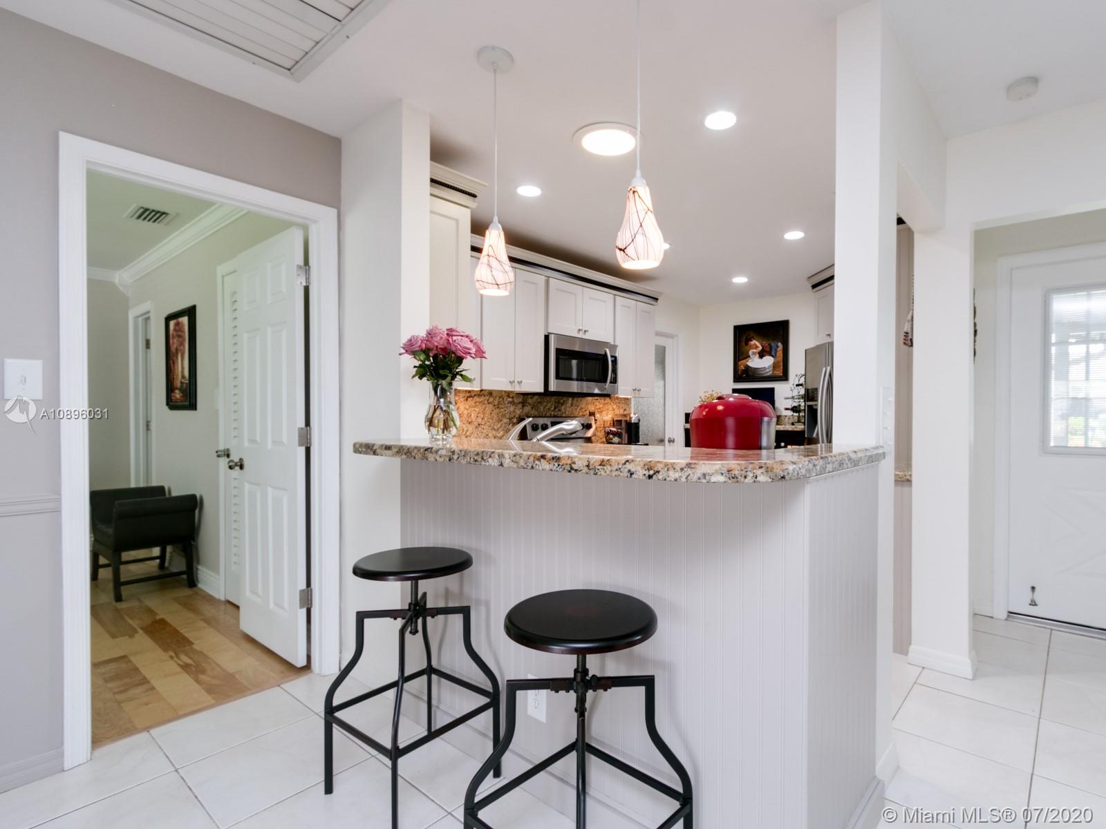 9518 Burlington Place Boca Raton, FL 33434 - Photo 6 of 35 a kitchen with stainless steel appliances granite countertop a refrigerator and a stove top oven with wooden floor