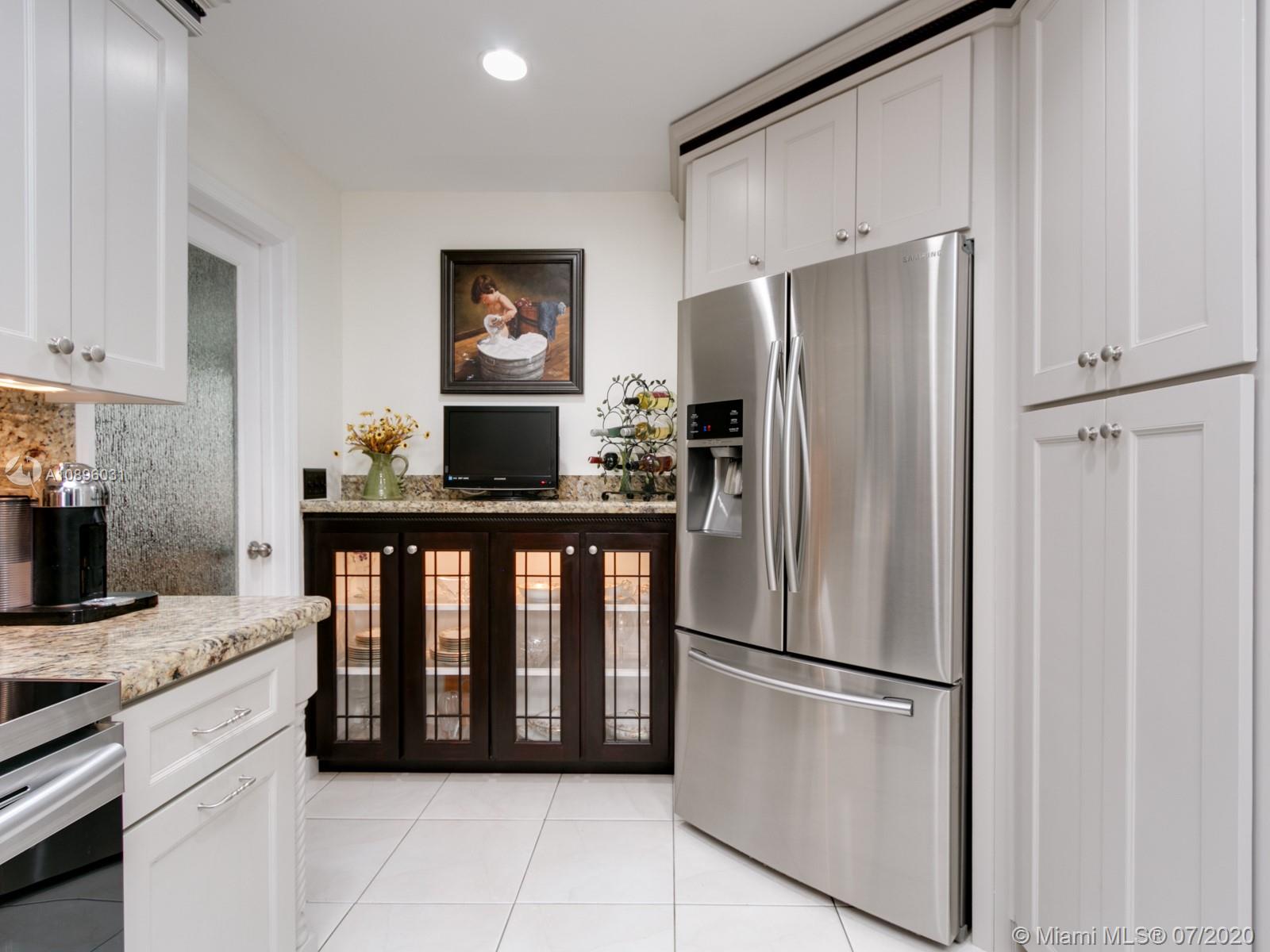 9518 Burlington Place Boca Raton, FL 33434 - Photo 8 of 35 a kitchen with stainless steel appliances a refrigerator sink and cabinets
