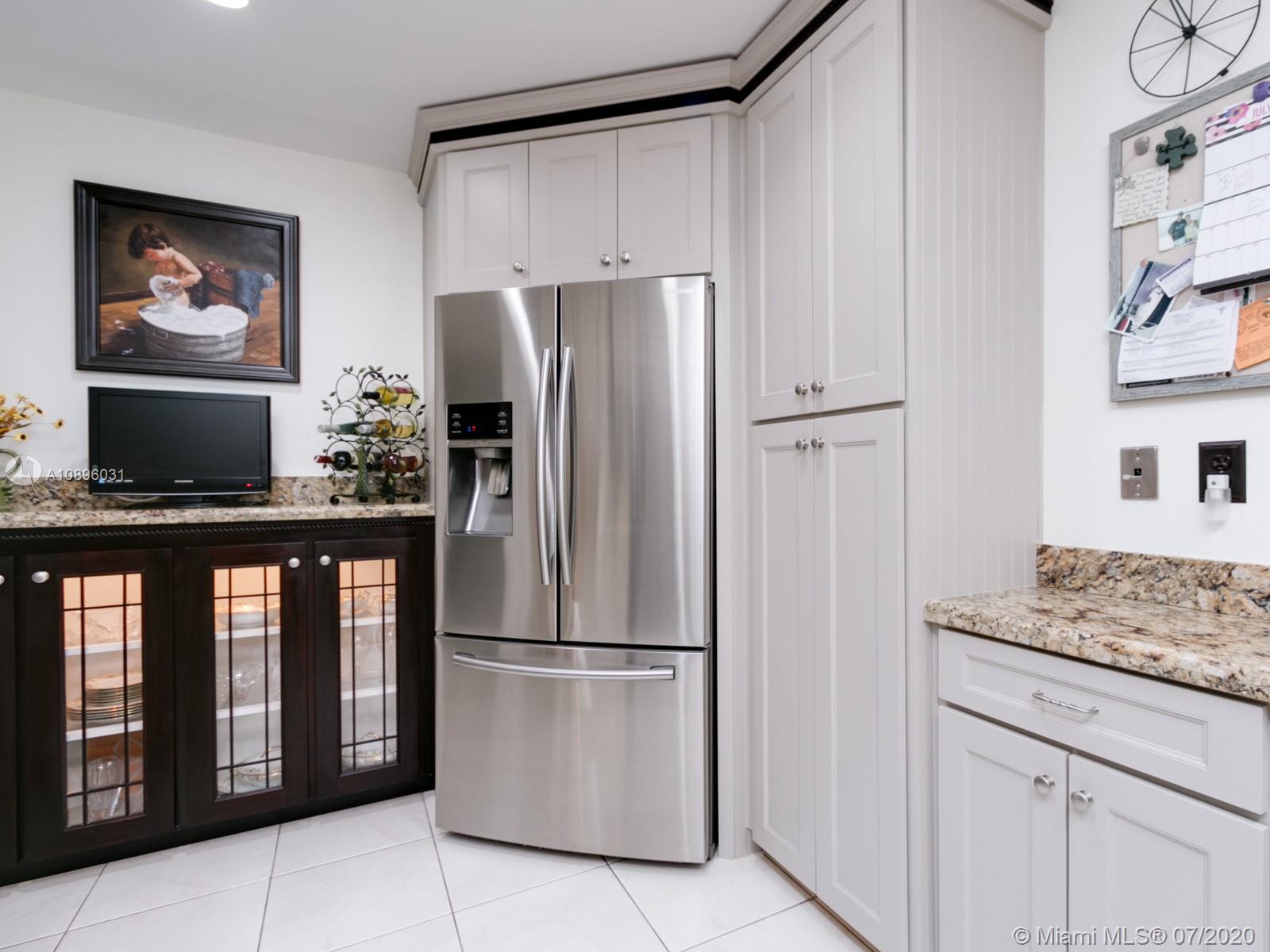 9518 Burlington Place Boca Raton, FL 33434 - Photo 9 of 35 a kitchen with stainless steel appliances granite countertop a refrigerator and a stove top oven