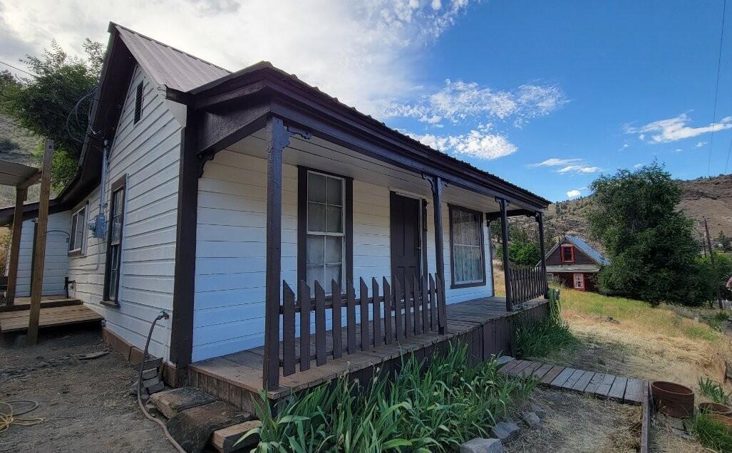 126 South Nelson Street Mitchell, OR 97750 - Photo 10 of 10 a view of a small house with wooden fence