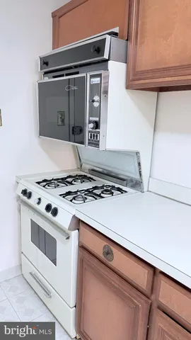 a stove top oven sitting inside of a kitchen