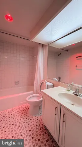 a bedroom with a bed and two chairs