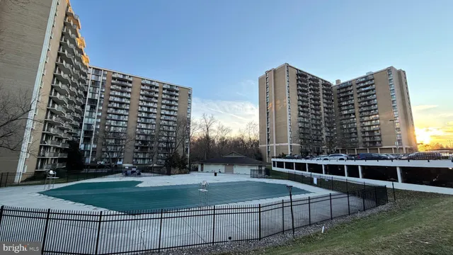 a view of outdoor space with building and trees in the background