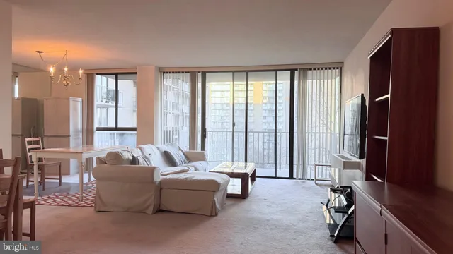 a living room with furniture and large windows