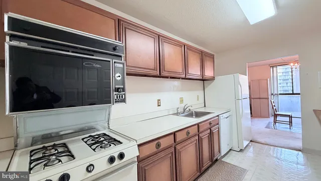 a kitchen with stainless steel appliances a stove a sink and a microwave