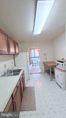 a spacious bathroom with a granite countertop sink and a mirror