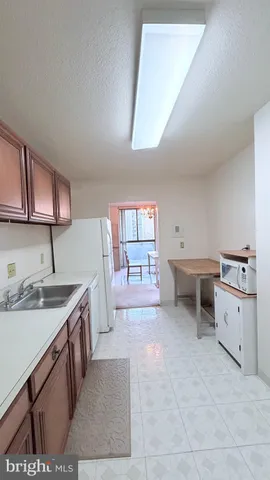 a large kitchen with a stove a sink dishwasher and a refrigerator
