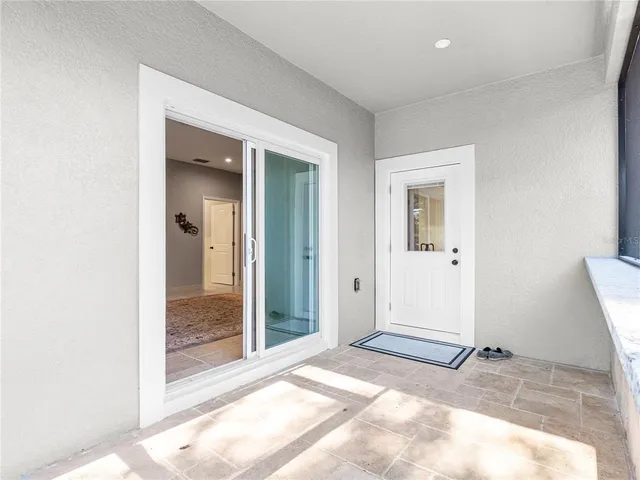 a view of a room with wooden floor and a bathroom