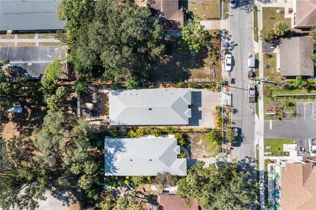 an aerial view of residential houses with outdoor space