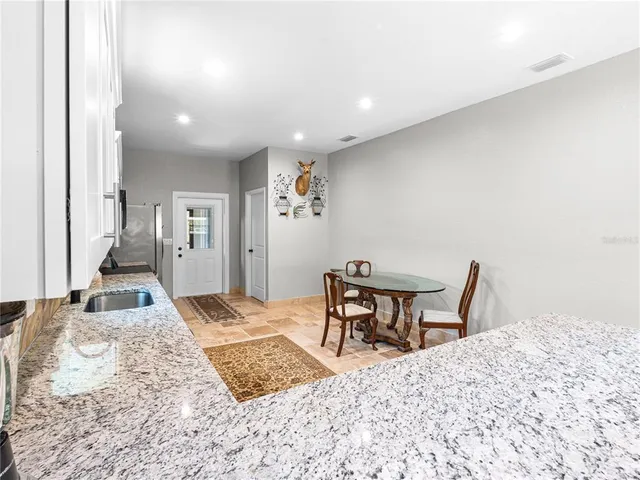 a view of a livingroom with wooden floor and furniture