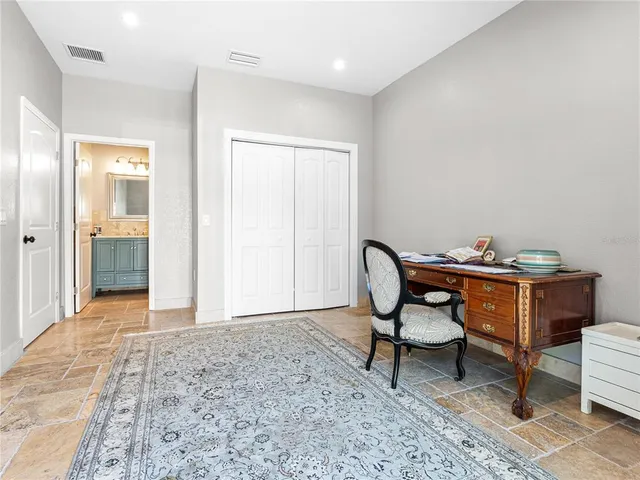 a view of a workspace with furniture and a bathroom