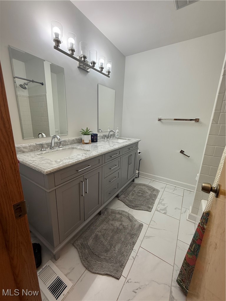 4669 Mars Road Uniontown, OH 44685 - Photo 20 of 31 Bathroom with visible vents, marble finish floor, and a sink
