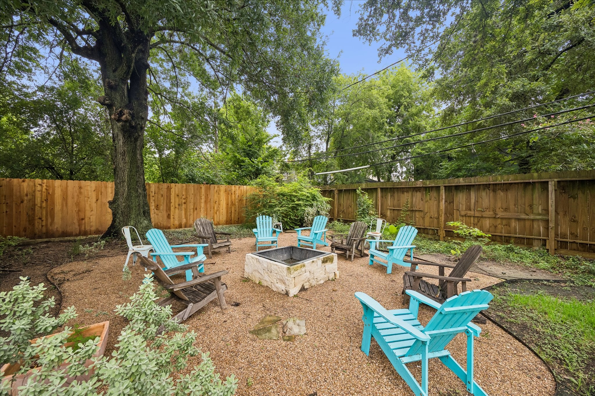3231 North MacGregor Way Houston, TX 77004 - Photo 22 of 22 Charming sitting area in a large backyard featuring a built-in fire pit