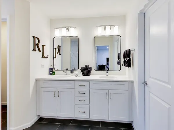 a bathroom with double sink and a mirror