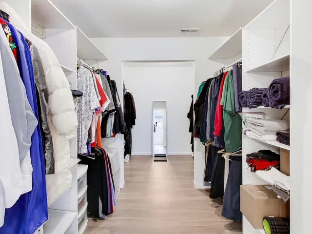 a view of walk in closet with clothes