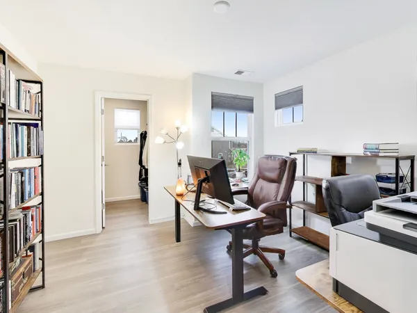 a living room with furniture and a book shelf