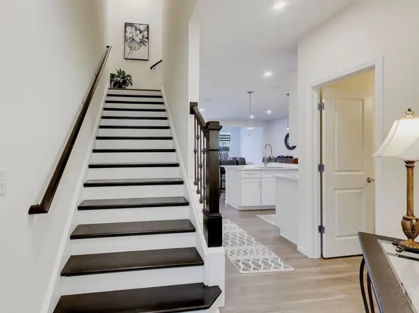 a view of entryway and hall with wooden floor