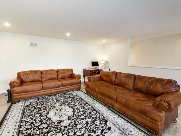 a living room with a couch and a rug