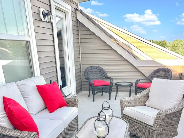 a view of a patio with couches table and chairs and potted plants
