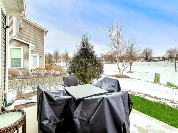 a view of a patio with furniture and a yard