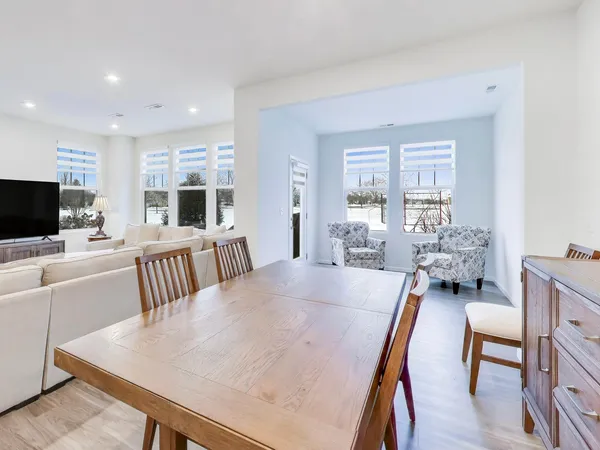 a view of a dining room with furniture window and wooden floor