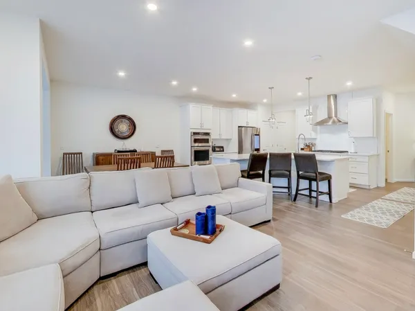 a living room with furniture and kitchen view