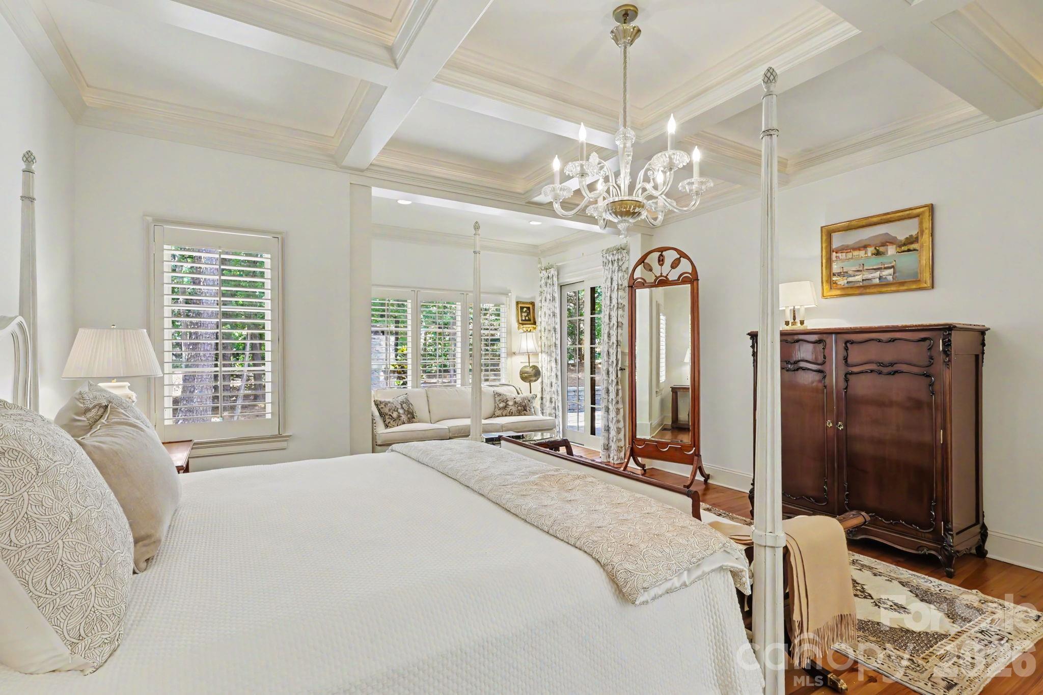 508 Hideaway Ridge Court Matthews, NC 28105 - Photo 10 of 47 a spacious bedroom with a bed and a chandelier