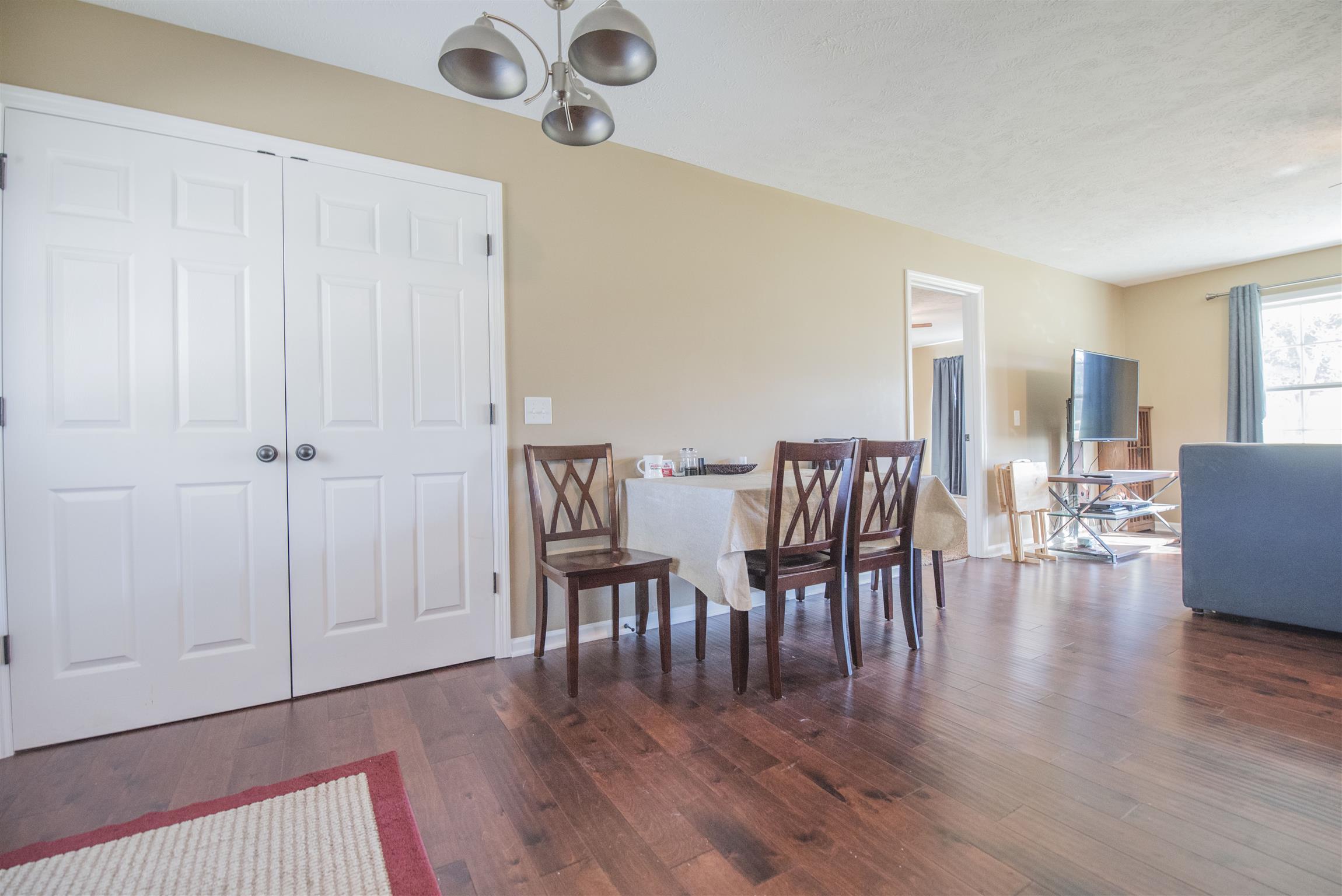 148 New Hope Road Manchester, TN 37355 - Photo 12 of 30 a dining room with furniture wooden floor a rug and a painting