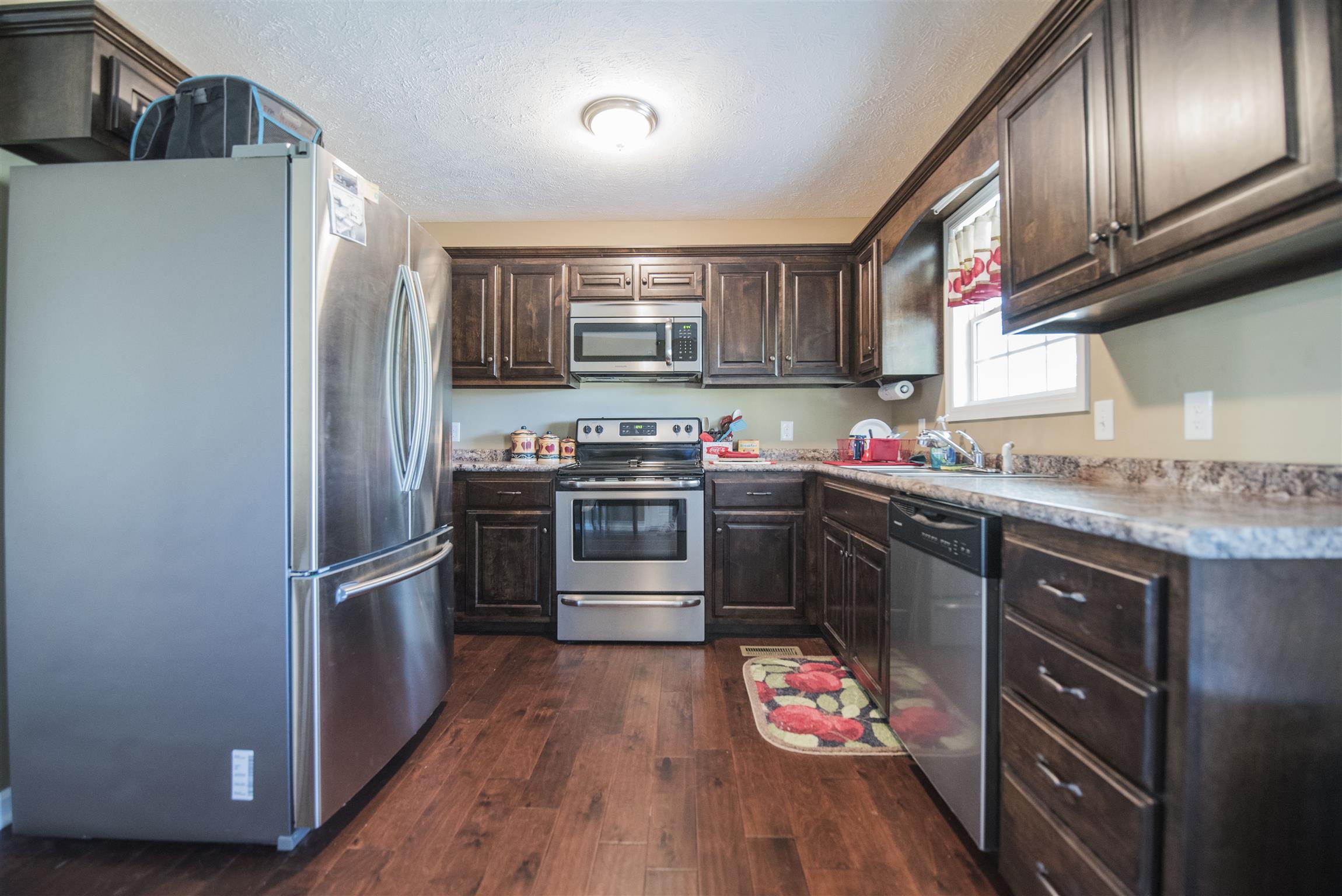 148 New Hope Road Manchester, TN 37355 - Photo 14 of 30 a kitchen with stainless steel appliances granite countertop a sink stove and refrigerator