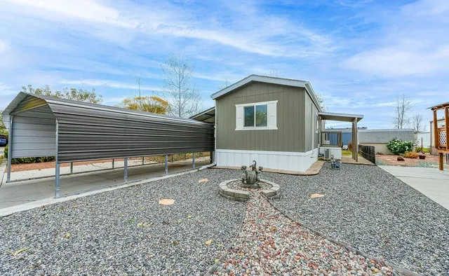 a backyard of a house with table and chairs