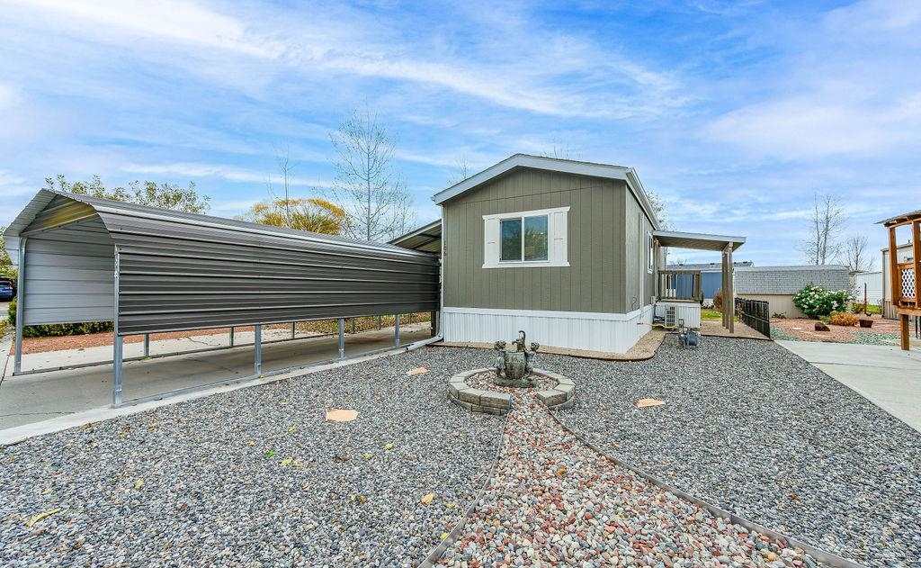 3251 E Road, Unit 106 Clifton, CO 81520 - Photo 16 of 16 a backyard of a house with table and chairs