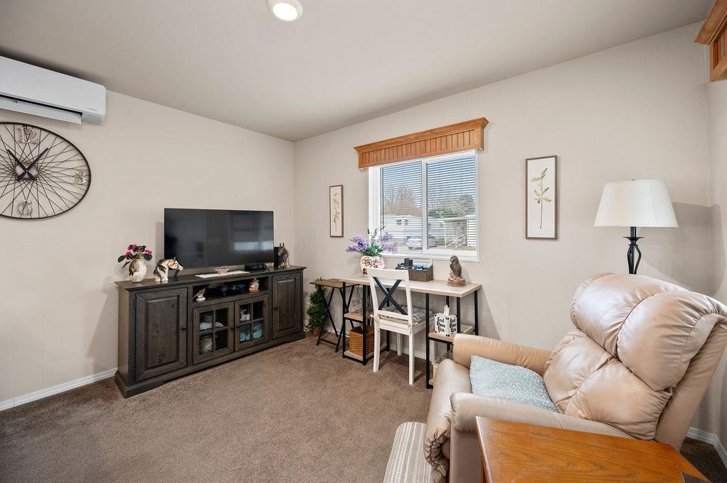 3251 E Road, Unit 106 Clifton, CO 81520 - Photo 4 of 16 a living room with furniture and a flat screen tv